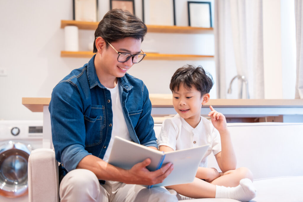 Parent and child reading together pointing at the words in the book